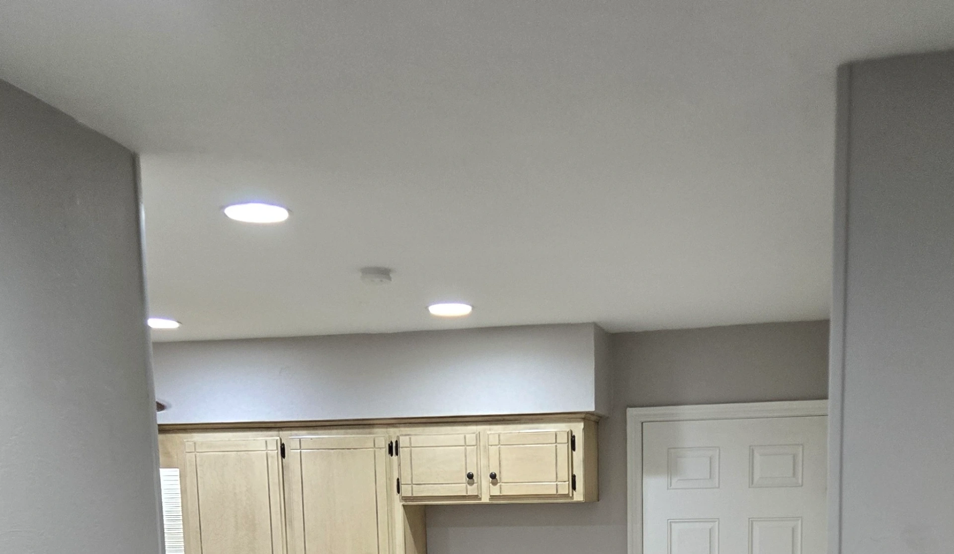 Professionally repaired and patched drywall ceiling with recessed lighting in Stillwater kitchen