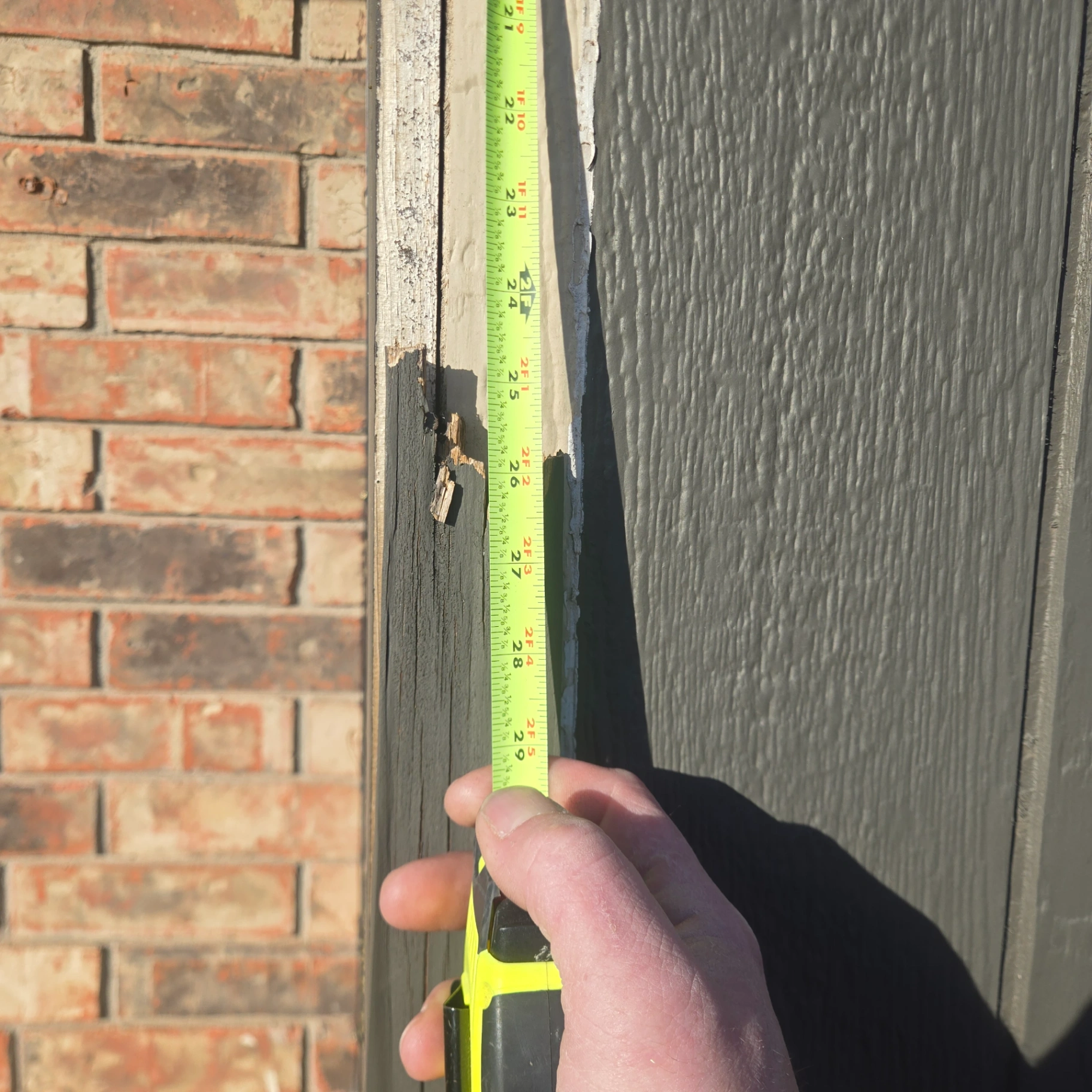 Measuring damaged exterior siding for repair before painting in Stillwater OK