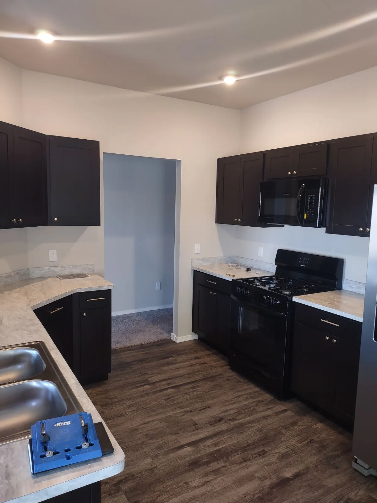 Modern kitchen with dark cabinets and new appliances installed by Stillwater Handymen LLC