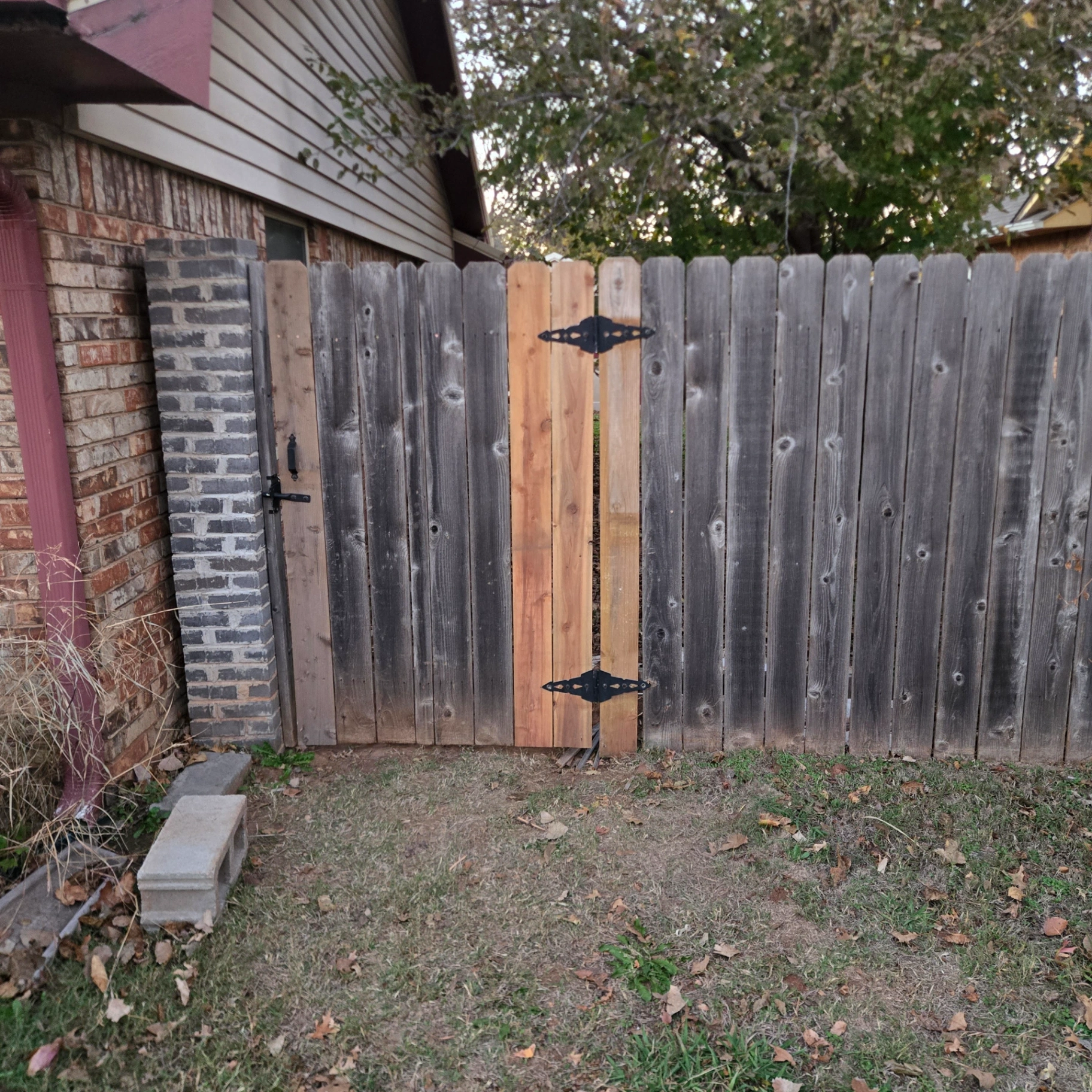Wooden privacy fence gate repair and installation by Stillwater Handymen LLC