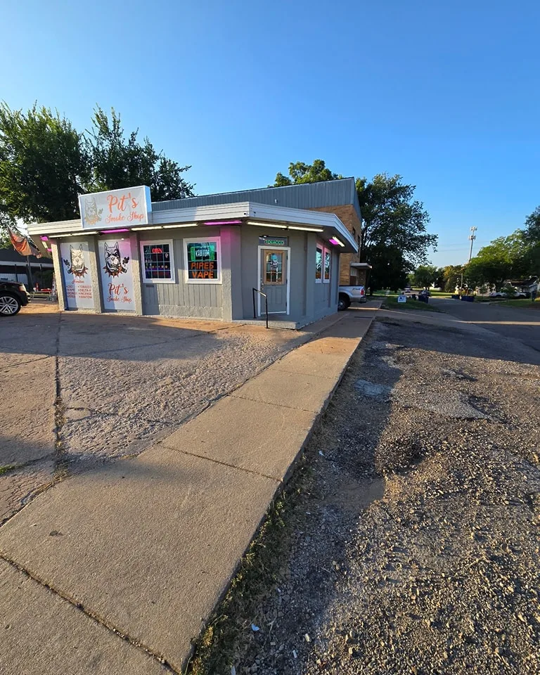 Pit's Smoke Shop before exterior painting showing old grey building facade in Stillwater OK