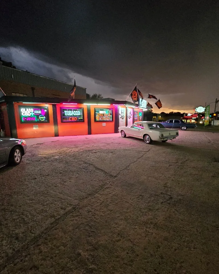 Pit's Smoke Shop completed commercial exterior painting project - full building night view in Stillwater OK