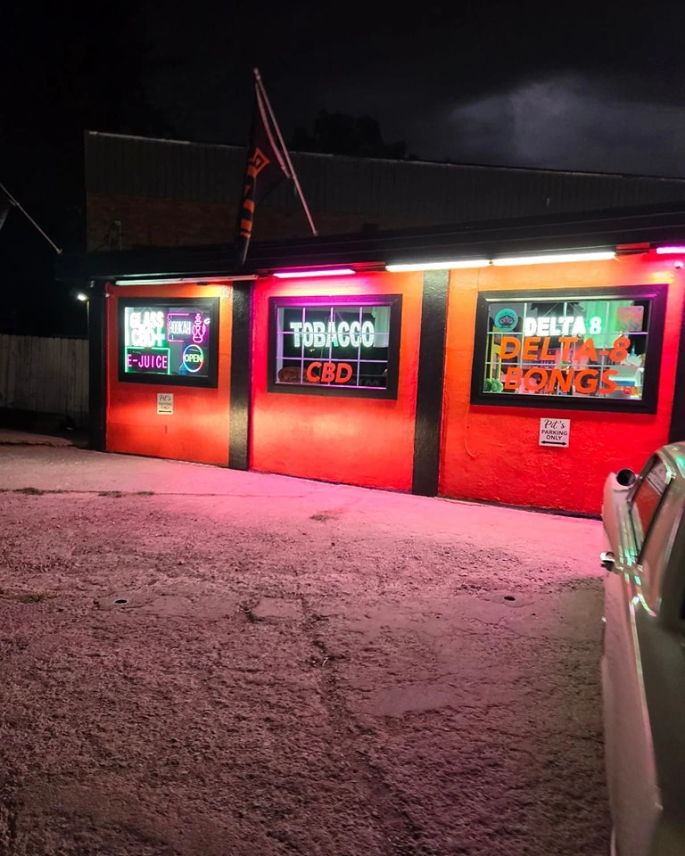 Pit's Smoke Shop night view showcasing finished orange commercial paint job