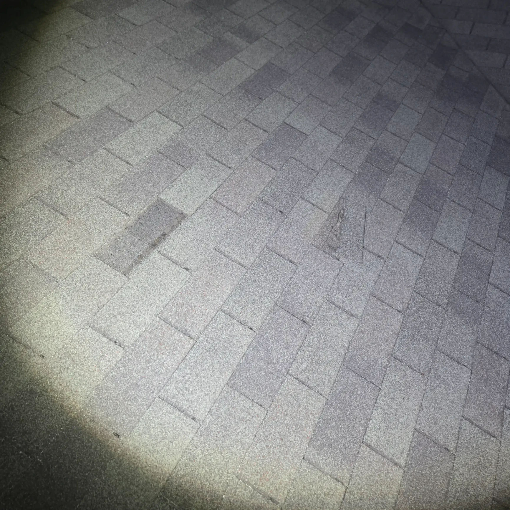 Damaged asphalt shingles on residential roof in Stillwater OK